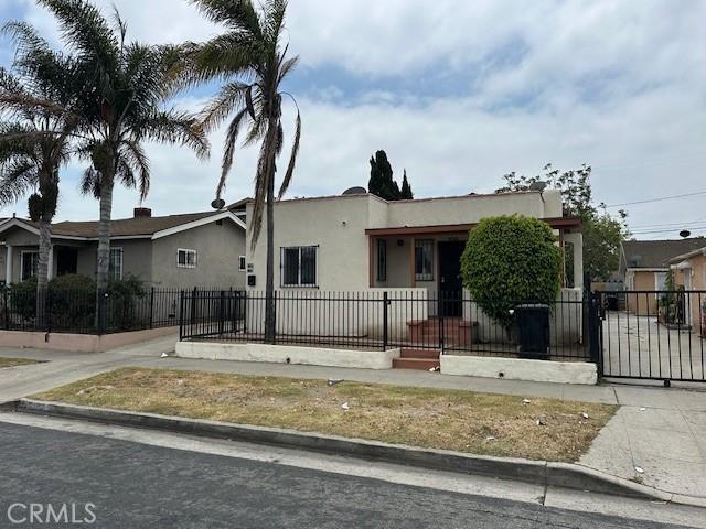 536 W Century Blvd, Los Angeles, CA 90044 - view of front of home with a fenced front yard, stucco siding, and a gate