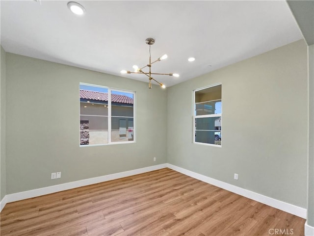 27117 Great Plains Ct, Menifee, CA 92585 - unfurnished room with a chandelier, wood finished floors, baseboards, and recessed lighting