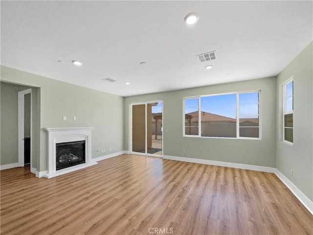 27117 Great Plains Ct, Menifee, CA 92585 - unfurnished living room with light wood-type flooring, a fireplace, baseboards, and recessed lighting