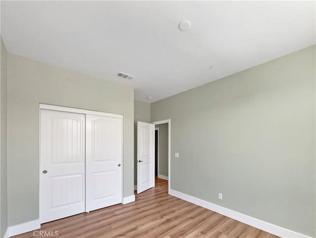27117 Great Plains Ct, Menifee, CA 92585 - unfurnished bedroom featuring light wood finished floors, a closet, and baseboards