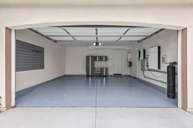13403 Hudson Ln, San Diego, CA 92130 - garage featuring baseboards and water heater