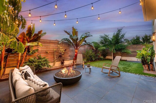 13403 Hudson Ln, San Diego, CA 92130 - fenced backyard featuring a patio area and an outdoor living space with a fire pit