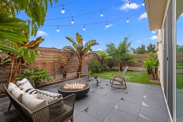 13403 Hudson Ln, San Diego, CA 92130 - fenced backyard featuring a patio and an outdoor living space with a fire pit