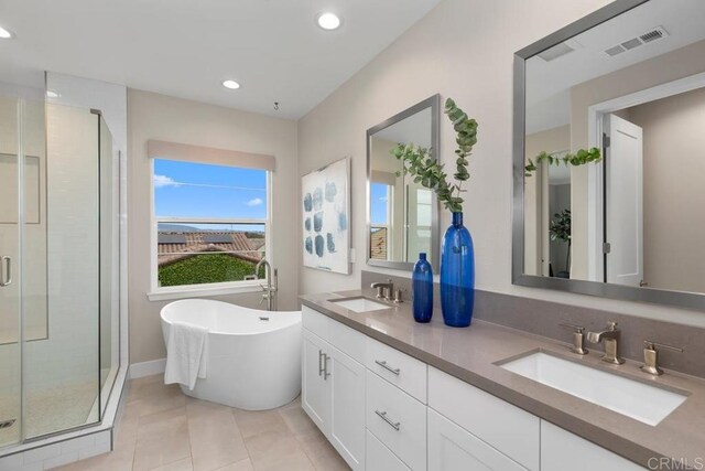 13403 Hudson Ln, San Diego, CA 92130 - full bath featuring double vanity, a stall shower, recessed lighting, a freestanding tub, and tile patterned floors