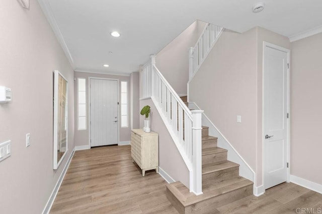 13403 Hudson Ln, San Diego, CA 92130 - foyer with light wood finished floors, crown molding, stairs, and recessed lighting