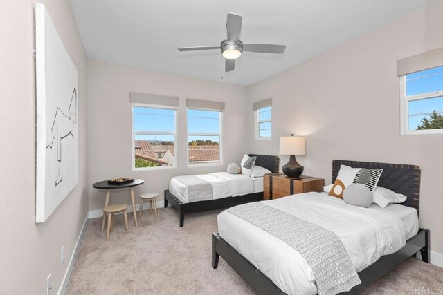 13403 Hudson Ln, San Diego, CA 92130 - bedroom featuring multiple windows, light colored carpet, and a ceiling fan