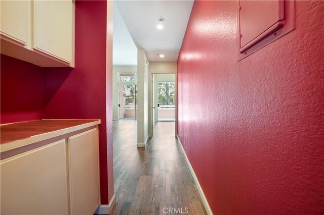 3690 S Bear St Unit 5, Santa Ana, CA 92704 - corridor featuring wood finished floors, baseboards, recessed lighting, and a textured wall