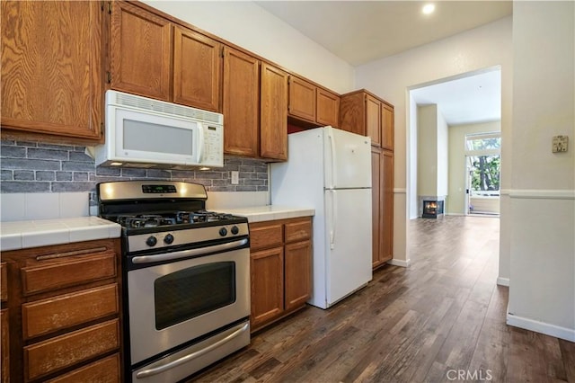 3690 S Bear St Unit 5, Santa Ana, CA 92704 - kitchen featuring white appliances, tile counters, decorative backsplash, dark wood finished floors, and brown cabinets