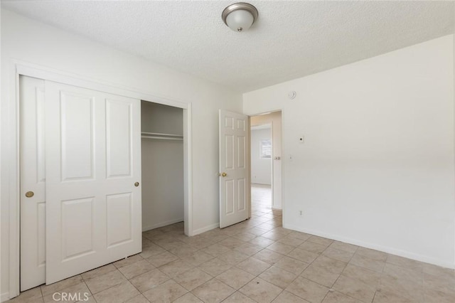 1437 S Gaffey St, San Pedro, CA 90731 - unfurnished bedroom with a textured ceiling, a closet, baseboards, and light tile patterned flooring