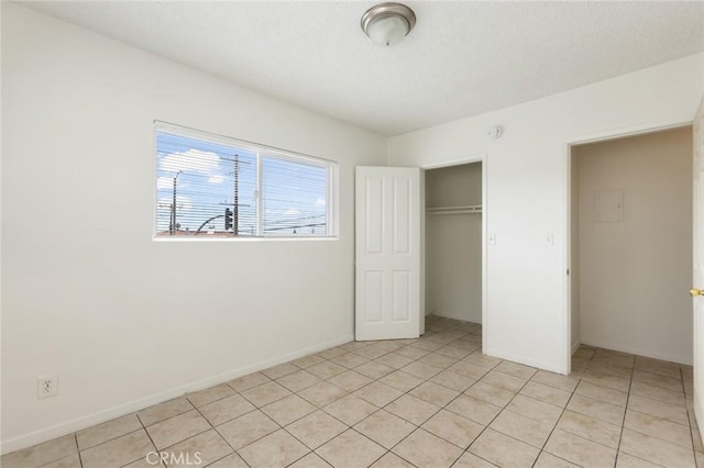 1437 S Gaffey St, San Pedro, CA 90731 - unfurnished bedroom featuring light tile patterned floors, a closet, and baseboards