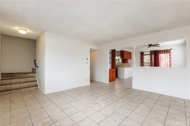 1437 S Gaffey St, San Pedro, CA 90731 - empty room with a textured ceiling, light tile patterned floors, stairway, and a ceiling fan