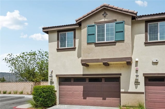 24117 Dolcetto Ave Unit 104, Murrieta, CA 92562 - view of front of home featuring stucco siding, a garage, and concrete driveway