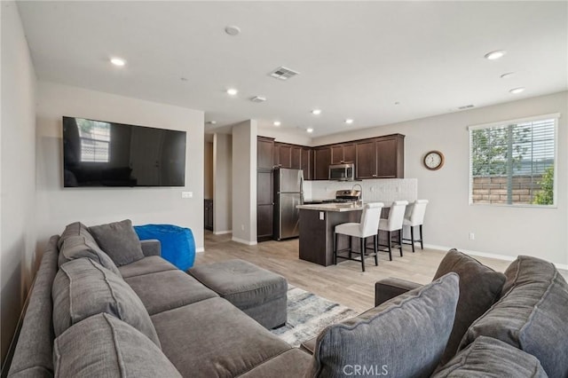 24117 Dolcetto Ave Unit 104, Murrieta, CA 92562 - living room with light wood-style floors, recessed lighting, and baseboards