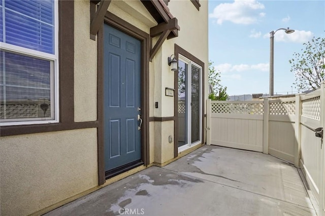 24117 Dolcetto Ave Unit 104, Murrieta, CA 92562 - doorway to property with stucco siding and a patio