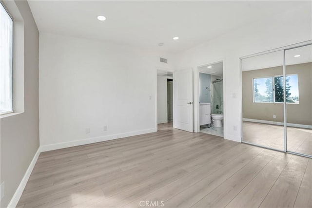 11150 Glenoaks Blvd Unit 106, Pacoima, CA 91331 - unfurnished bedroom featuring light wood-style floors, baseboards, recessed lighting, a closet, and ensuite bathroom