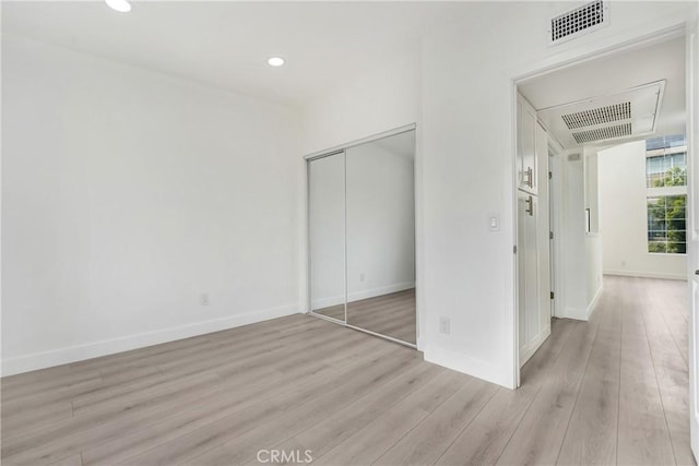 11150 Glenoaks Blvd Unit 106, Pacoima, CA 91331 - unfurnished bedroom with light wood finished floors, baseboards, a closet, and recessed lighting