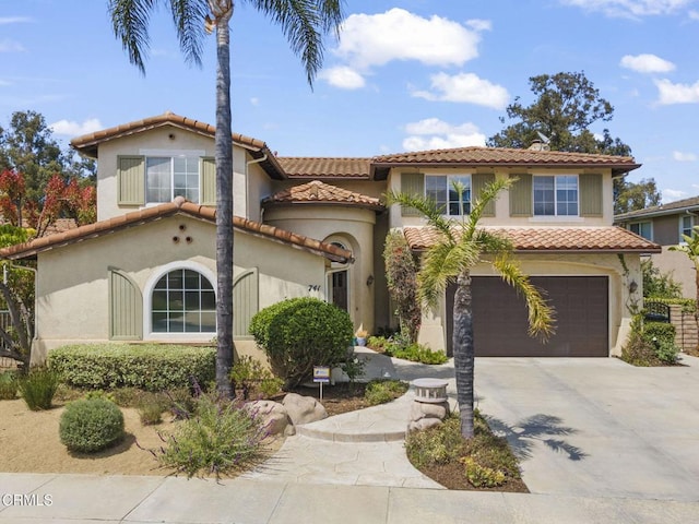 741 Sterling Hills Dr, Camarillo, CA 93010 - mediterranean / spanish home featuring a garage, stucco siding, a tiled roof, and driveway