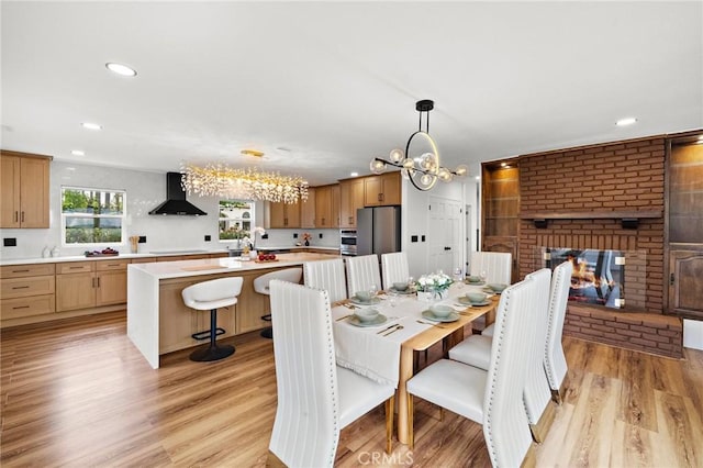22621 Ridge Line Rd, Diamond Bar, CA 91765 - dining room featuring a chandelier, light wood-type flooring, recessed lighting, and a fireplace