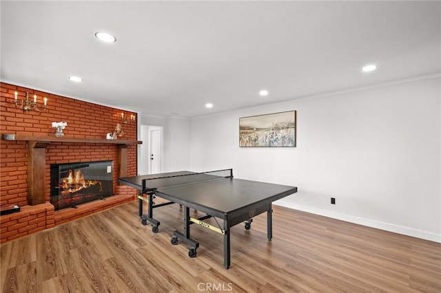 22621 Ridge Line Rd, Diamond Bar, CA 91765 - recreation room featuring a fireplace, wood finished floors, baseboards, recessed lighting, and ornamental molding