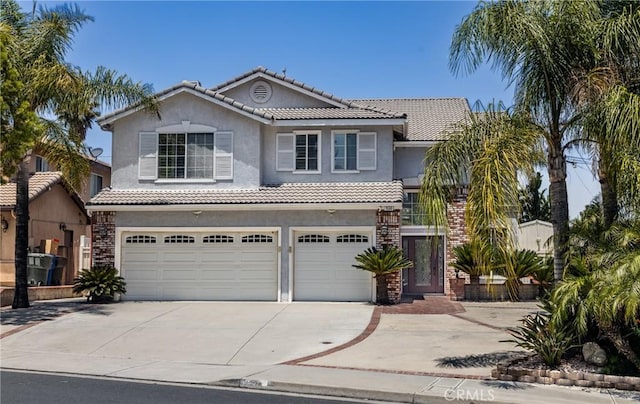 1550 Jameson Ct, Riverside, CA 92507 - view of front of home with a garage, concrete driveway, stucco siding, and a tile roof