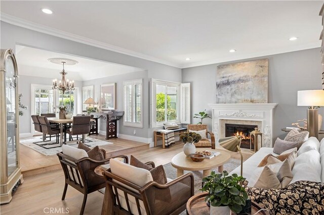 21035 Timber Ridge Rd, Yorba Linda, CA 92886 - living room featuring a glass covered fireplace, a chandelier, light wood-type flooring, recessed lighting, and crown molding