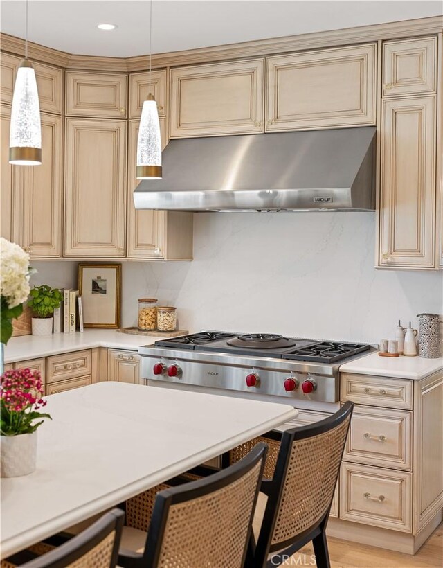 21035 Timber Ridge Rd, Yorba Linda, CA 92886 - kitchen with under cabinet range hood, light countertops, pendant lighting, stainless steel gas cooktop, and cream cabinetry