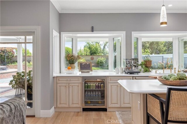 21035 Timber Ridge Rd, Yorba Linda, CA 92886 - bar area featuring beverage cooler, light wood-style flooring, ornamental molding, and hanging light fixtures