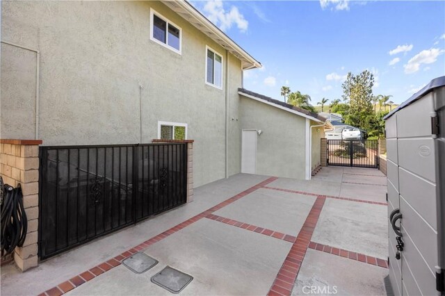 21035 Timber Ridge Rd, Yorba Linda, CA 92886 - rear view of property with a gate, stucco siding, and a patio area