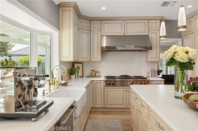 21035 Timber Ridge Rd, Yorba Linda, CA 92886 - kitchen with under cabinet range hood, appliances with stainless steel finishes, cream cabinetry, and recessed lighting