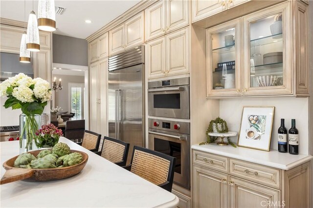 21035 Timber Ridge Rd, Yorba Linda, CA 92886 - kitchen featuring cream cabinets, appliances with stainless steel finishes, light countertops, decorative light fixtures, and glass insert cabinets