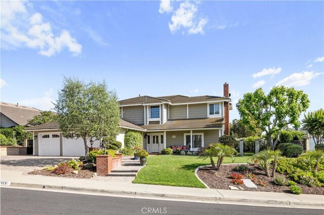 21035 Timber Ridge Rd, Yorba Linda, CA 92886 - traditional-style house with an attached garage, driveway, and a chimney