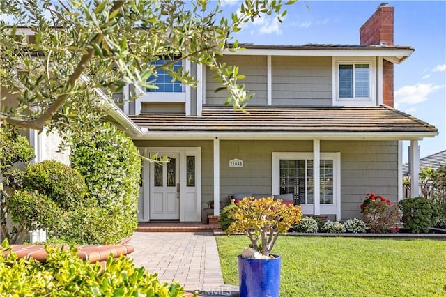 21035 Timber Ridge Rd, Yorba Linda, CA 92886 - view of front of house with a chimney, a porch, and a front lawn