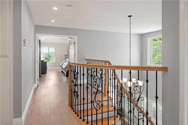 21035 Timber Ridge Rd, Yorba Linda, CA 92886 - corridor with an upstairs landing, healthy amount of natural light, wood-type flooring, a chandelier, and recessed lighting