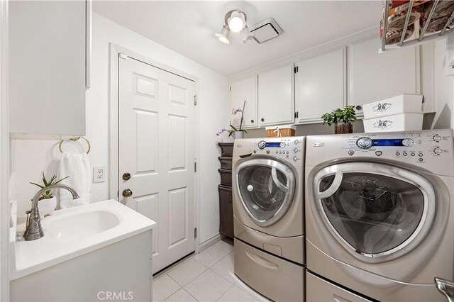 21035 Timber Ridge Rd, Yorba Linda, CA 92886 - washroom featuring washing machine and clothes dryer, cabinet space, and light tile patterned floors
