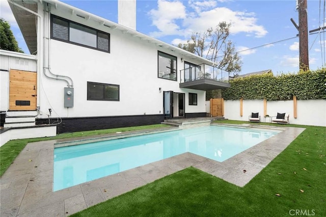 2416 Palm Ave, Manhattan Beach, CA 90266 - back of property with a balcony, an outdoor pool, stucco siding, a chimney, and a patio area