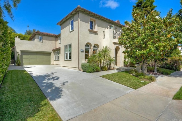 3518 Camino Cereza, Carlsbad, CA 92009 - mediterranean / spanish home featuring a balcony, stucco siding, concrete driveway, a garage, and a front yard