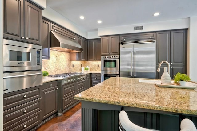 3518 Camino Cereza, Carlsbad, CA 92009 - kitchen featuring built in appliances, a warming drawer, ventilation hood, light stone counters, and decorative backsplash