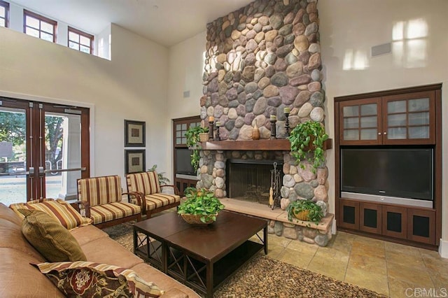 3518 Camino Cereza, Carlsbad, CA 92009 - living room featuring a high ceiling, french doors, a fireplace, and stone tile floors