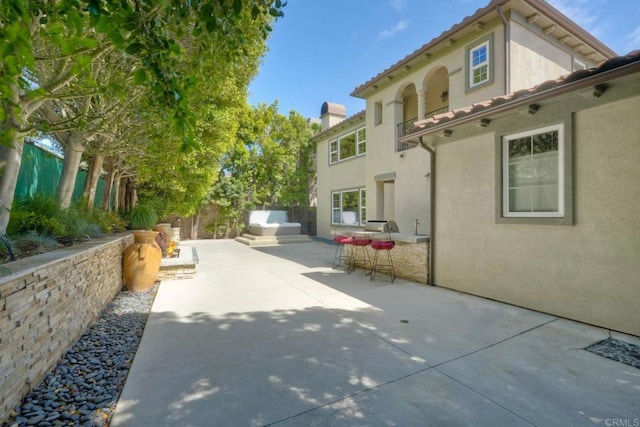 3518 Camino Cereza, Carlsbad, CA 92009 - exterior space featuring a patio area, stucco siding, a chimney, exterior kitchen, and outdoor dining space