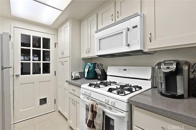 25520 Dodge Ave Unit A, Harbor City, CA 90710 - kitchen with white appliances, white cabinets, light tile patterned flooring, and stone countertops