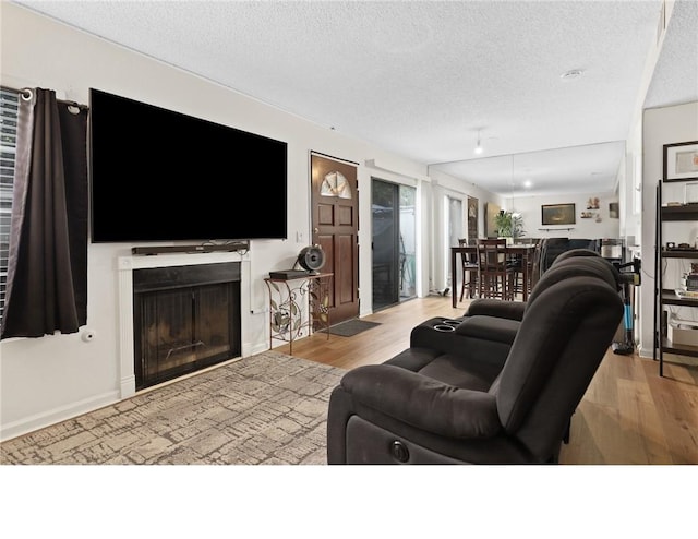 25520 Dodge Ave Unit A, Harbor City, CA 90710 - living area with a textured ceiling, wood finished floors, and a fireplace