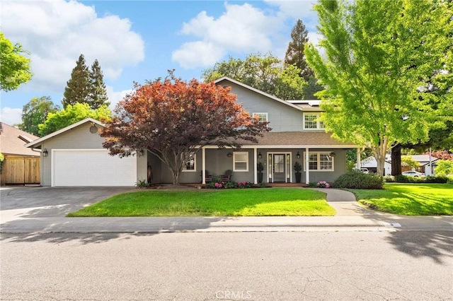 6 Stansbury Ct, Chico, CA 95928 - view of front of home with an attached garage, asphalt driveway, solar panels, and a porch