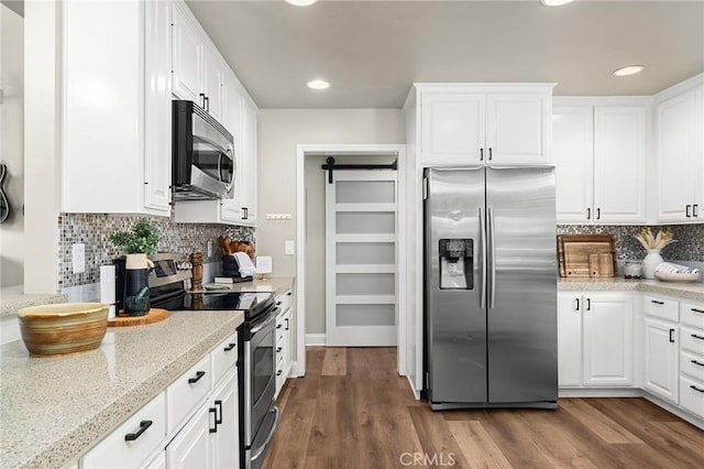 6 Stansbury Ct, Chico, CA 95928 - kitchen with appliances with stainless steel finishes, white cabinetry, backsplash, dark wood-style flooring, and light stone counters