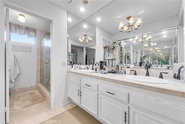 6232 E Shenandoah Ave, Orange, CA 92867 - bathroom featuring a chandelier, double vanity, tile patterned flooring, a stall shower, and recessed lighting