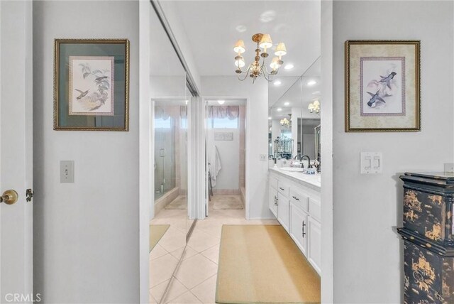 6232 E Shenandoah Ave, Orange, CA 92867 - full bathroom with double vanity, a chandelier, a shower stall, and tile patterned flooring