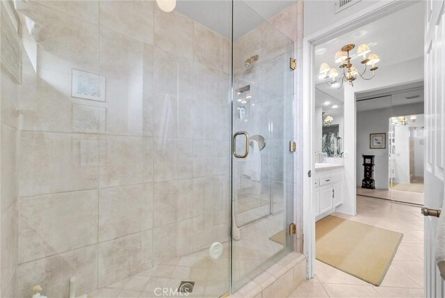 6232 E Shenandoah Ave, Orange, CA 92867 - bathroom featuring a stall shower, a chandelier, vanity, and tile patterned floors