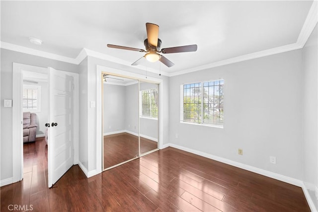 157 E 70th St, Los Angeles, CA 90003 - unfurnished bedroom featuring wood finished floors, a closet, baseboards, and ornamental molding