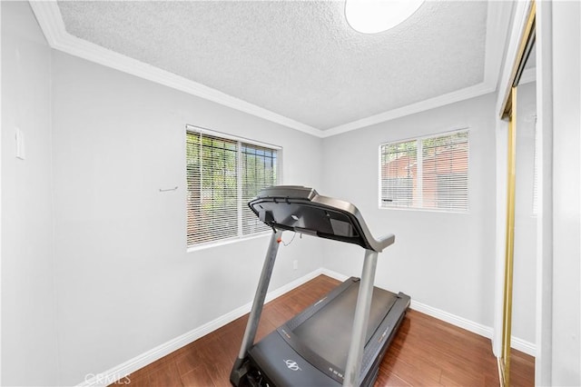 157 E 70th St, Los Angeles, CA 90003 - workout room with plenty of natural light, baseboards, wood finished floors, a textured ceiling, and ornamental molding