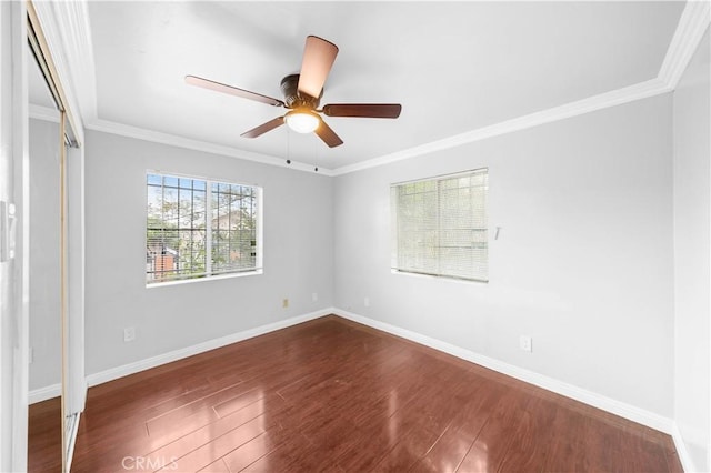 157 E 70th St, Los Angeles, CA 90003 - unfurnished bedroom featuring dark wood finished floors, crown molding, baseboards, and ceiling fan