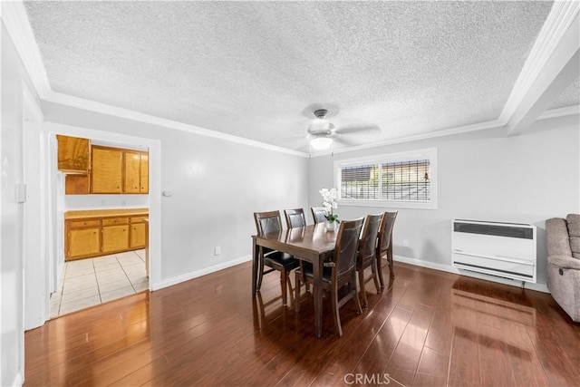 157 E 70th St, Los Angeles, CA 90003 - dining area with heating unit, a textured ceiling, a ceiling fan, dark wood-style floors, and crown molding